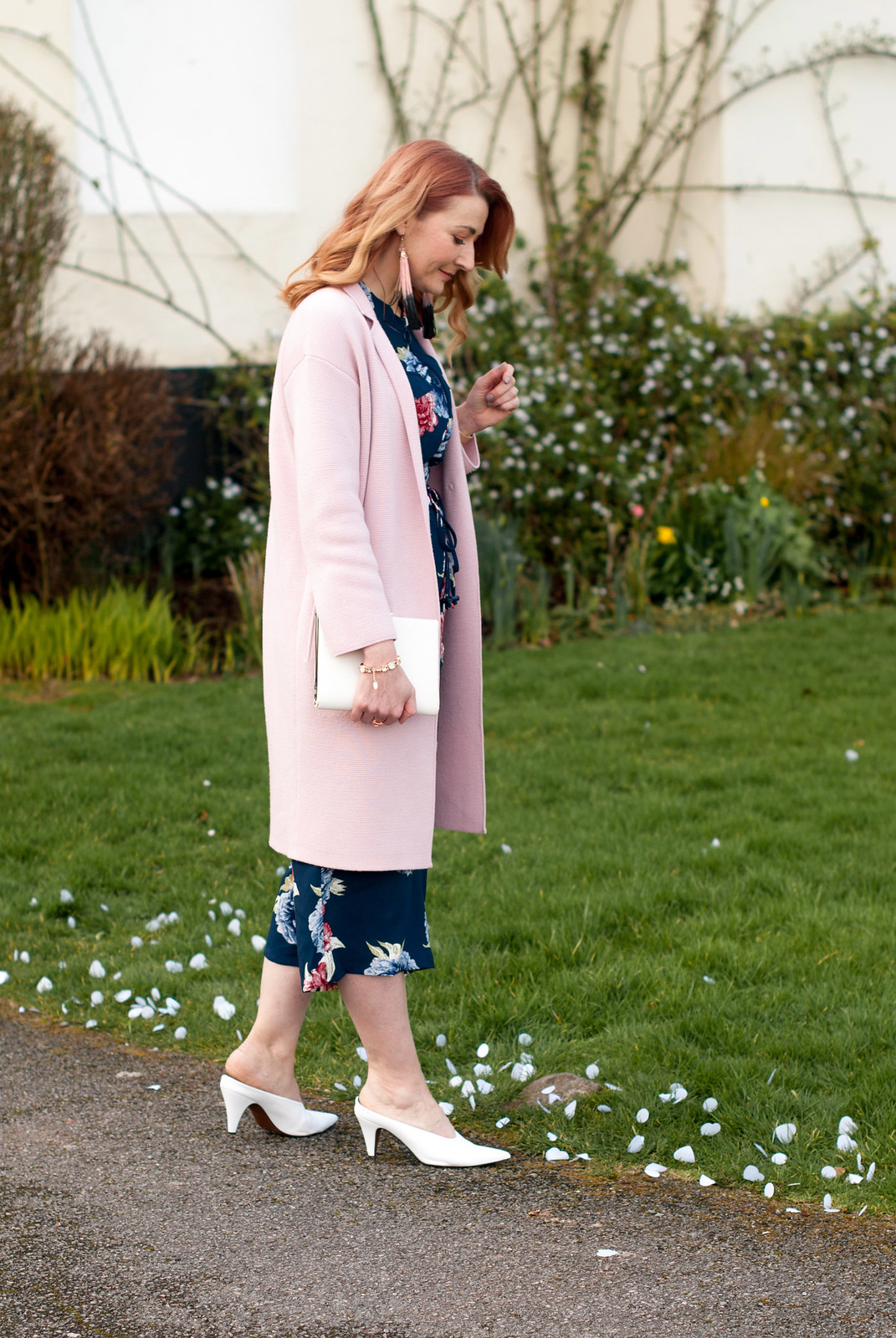 What to Wear to a Winter Wedding as a Wedding Guest - floral wide leg jumpsuit \ longline pink coatigan \ white pointed mules \ white clutch \ tassel earrings | Not Dressed As Lamb, over 40 style
