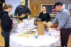 Student volunteers make care packages for troops