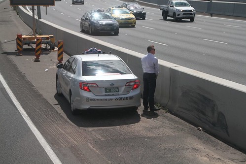 Taxi passenger taking a piss in the middle of the freeway