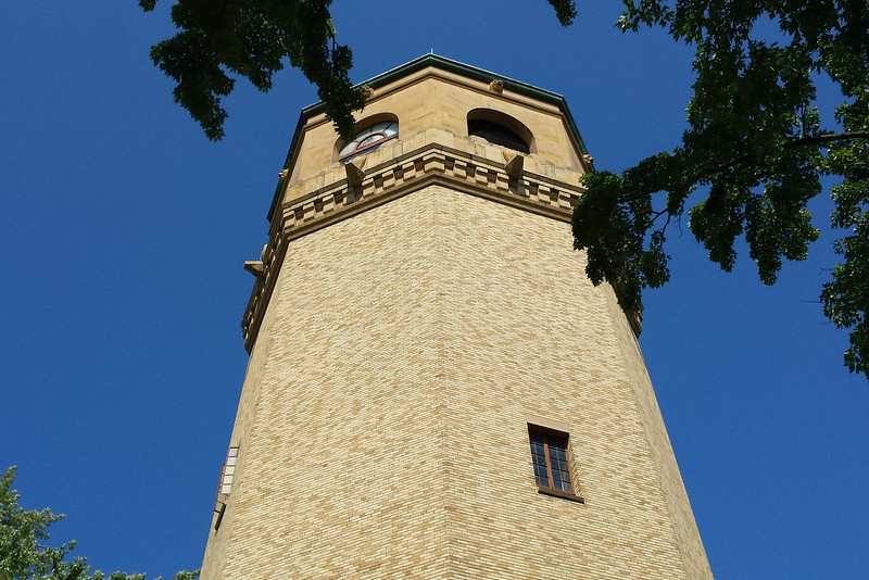looking up at the top of a six-sided brick water tower
