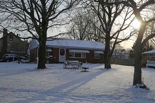house residence dwelling 1950s ranch modern contemporary bucyrus ohio crawford county snow winter morning shadow 11 windows door roof brick veneer picnic table awnings car automobile trees sun sunlight