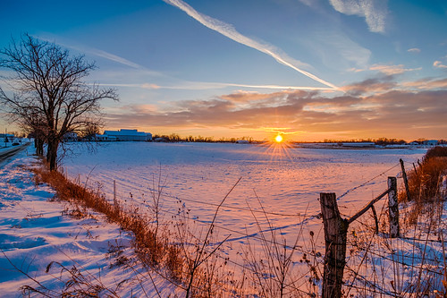 hdr indiana lagrangecounty nikon nikond5300 outdoor barbedwire barbedwirefence clouds cold evening farm fence geotagged landscape rural rustic sky snow sunburst sunset tree winter shipshewana unitedstates