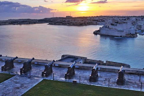 cannon fort light city buildings sunrise cityscape malta architecture water