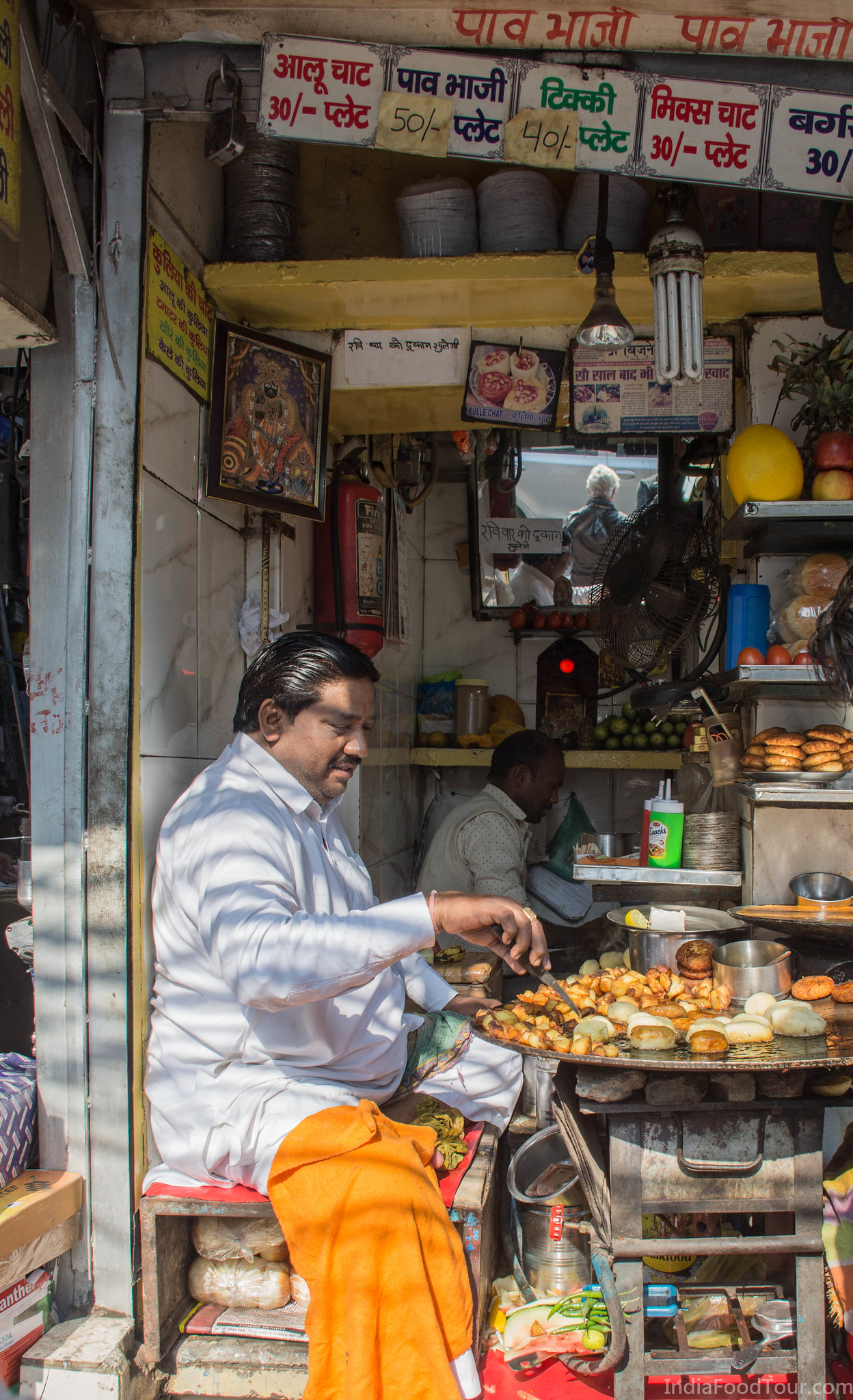 Owner of a 100 years old street food shop cooking Aaloo Chaat and Aaloo tikki