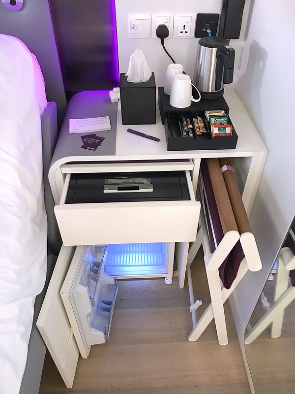 The compact bedside table fits the safe, fridge and chair!