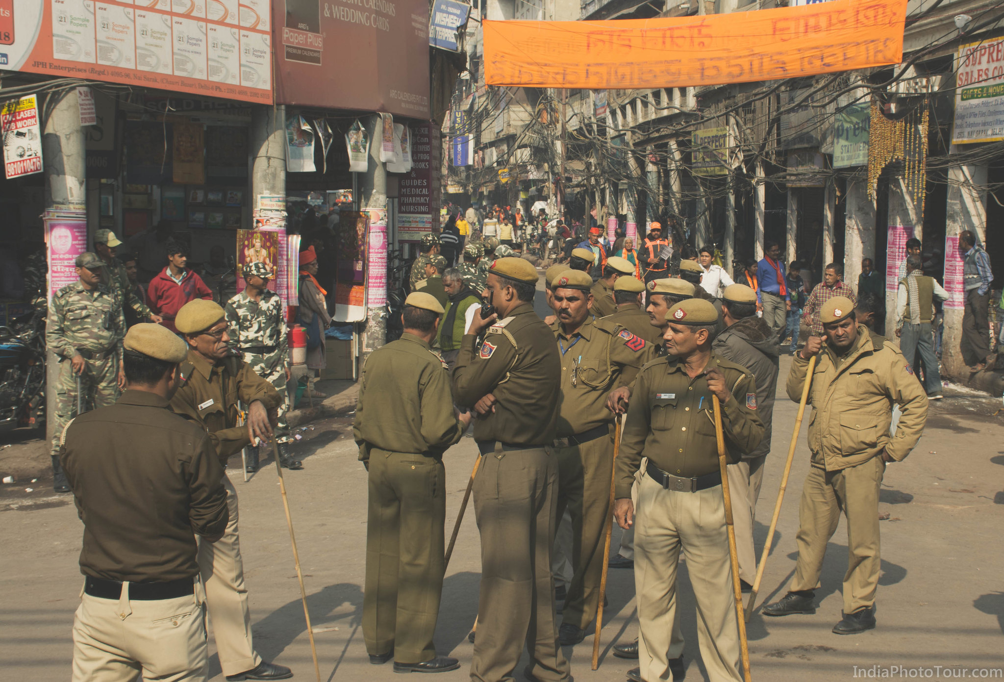 Local policemen on street managing crowd and traffic during a street procession