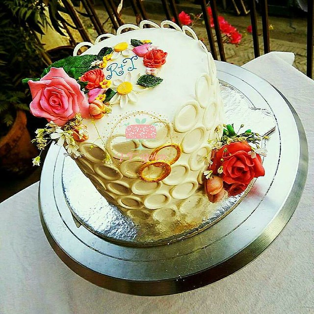 Whipped Cream Wedding Anniversary Cake with Fondant Accents. Whole cake including roses are edible. By Arti Trivedi of VT Bakers