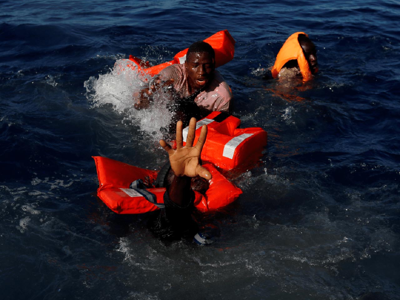 22 Photos From 2017 That Tell A Story: Migrants are trying to keep floating after their boat was capsized in the central Mediterranean during a rescue operation carried out by Non-governmental organization Migrant Offshore Aid Station.