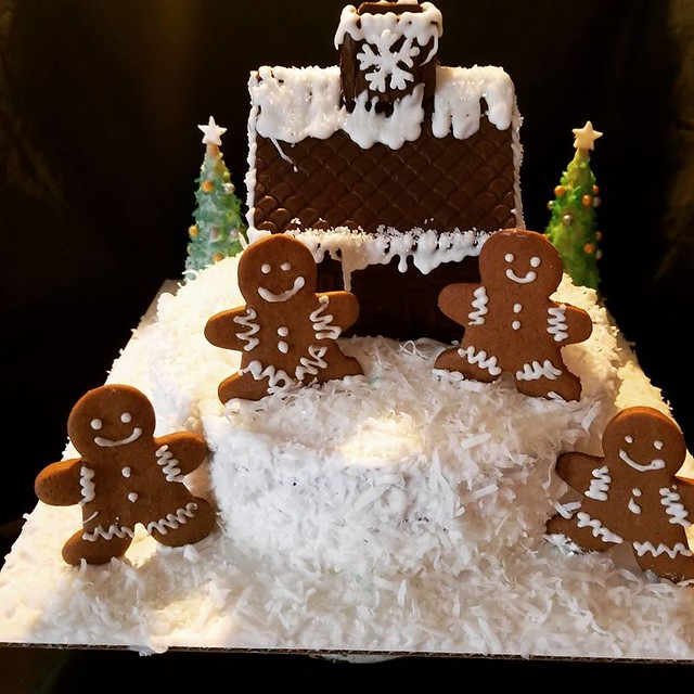 Winter wonder land, vanilla cake, butter cream frosting, coconut snow, gingerbread men, and a chocolate house. by Lori Holmes Preisinger of Nothing Fancy Cakes & Desserts by Lori
