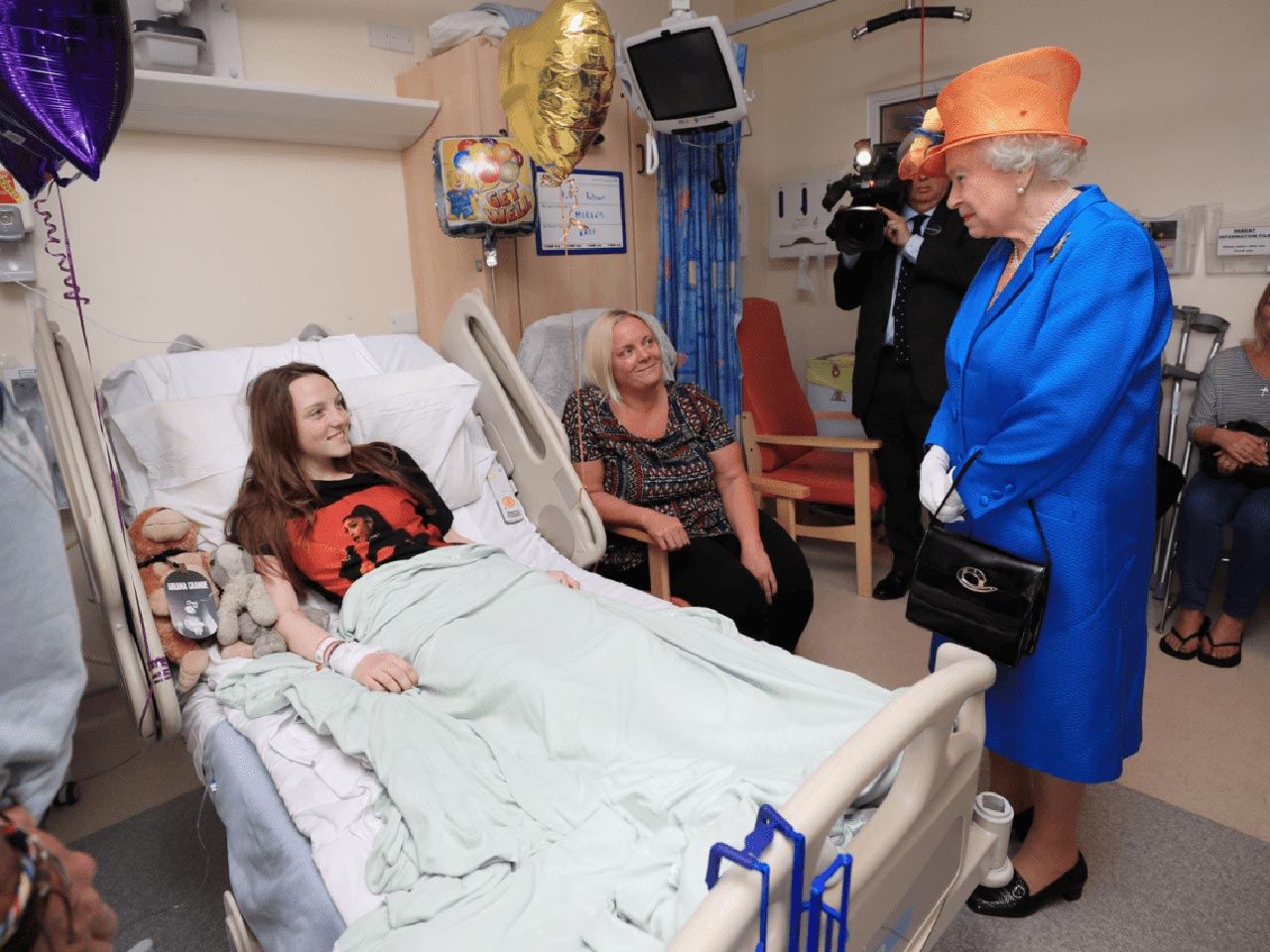 22 Photos From 2017 That Tell A Story: Queen Elizabeth is paying a visit to the Royal Manchester Children's Hospital and speaking to 15-year-old Millie Robson after Manchester Arena bombing.