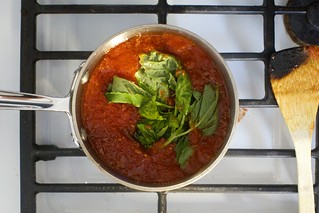 add the tomatoes, basil, then simmer