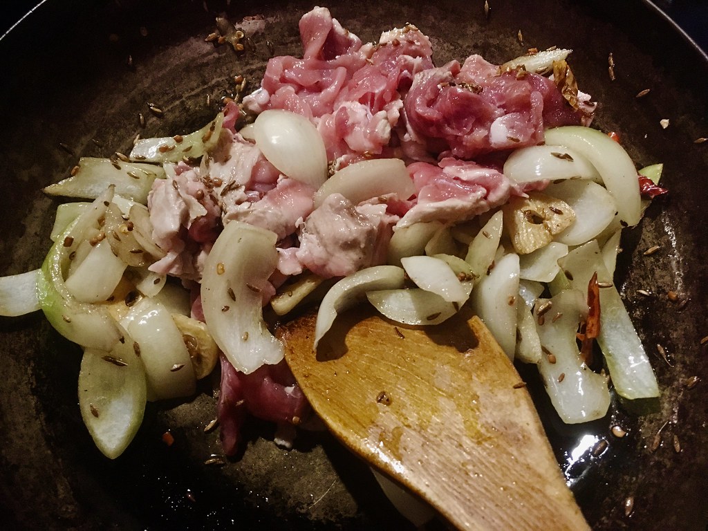 frying onion and pork meat