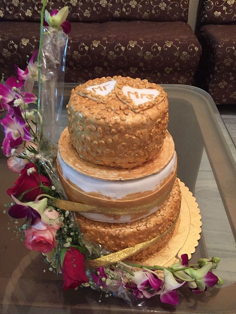Special Gold Theme Cake with Fresh Flowers for Wedding by Radha Manish
