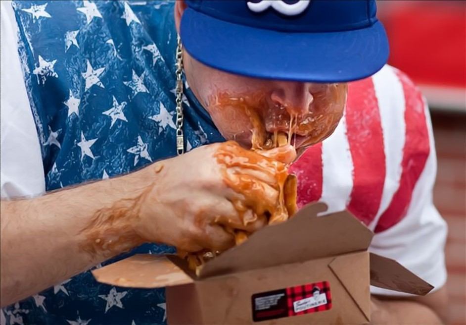World poutine-eating championship, Toronto, Canada, 2010 - by Miles Storey, Canadian