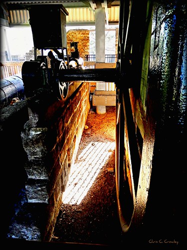 gearingup gears wheels spokes cog railing sunlight shadows sugarmillgardens dunlawtonplantation portorangeflorida historic