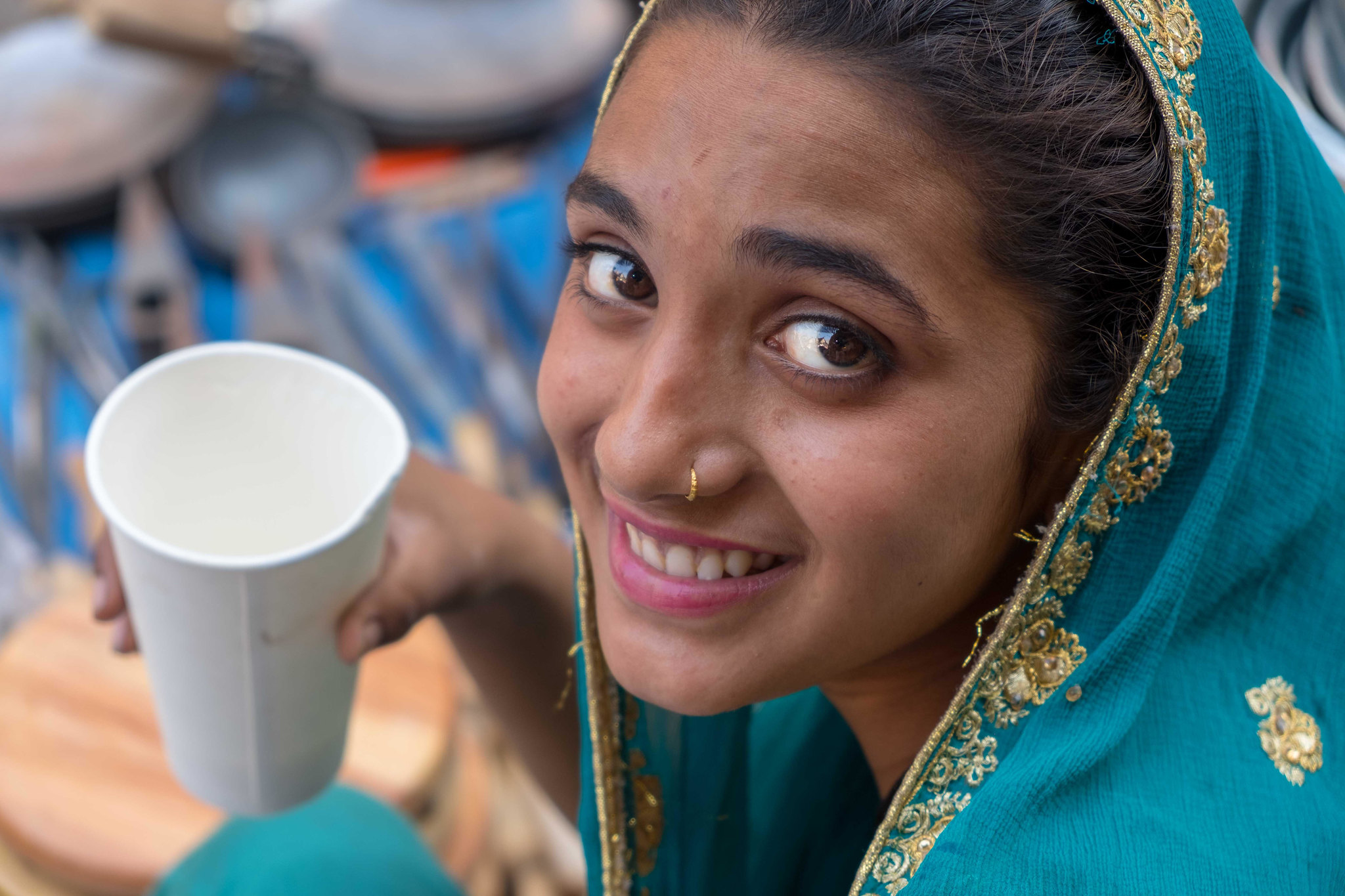 A young woman selling home made utensils on the street