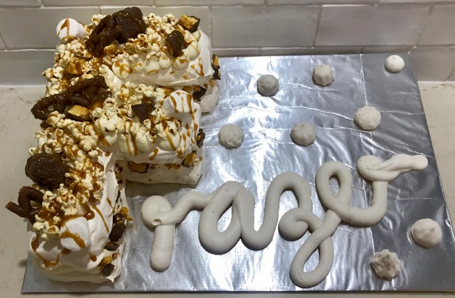 Pavlova with honeycomb, salted caramel, caramel popcorn marshmallow and curly whirly. Meringue writing and mini kisses. By Belinda Bristow of Bels Bakes