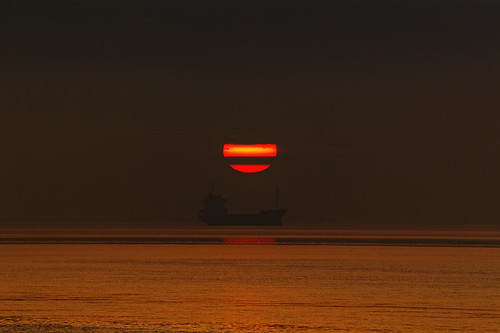 sunrise coaster vessel morning sun early humberestuary humberside water ship clouds sunlight silhouette fullframe canoneos1dxmkll ef100400 handheld