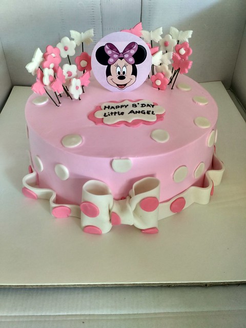 Minnie mouse theme cake for a little angel on her birthday. Alternate layers of vanilla and dark chocolate sponge, butterscotch filling and whipped cream frosting with fondant accents. By Chetana Yadav of Cake County
