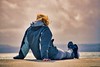 Woman sitting on a seawall. This image is provided on an as-is basis, royalty free for personal editorials, blogs and web display usage. - Royalty Free People & Candid Situations