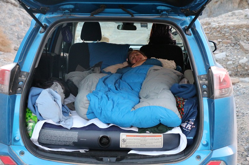  Vicki is lounging in the sleeping bag in the back of our rented Rav4 in Marble Canyon