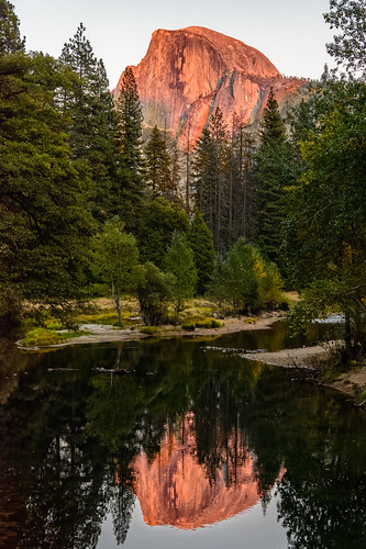 land photography time water cliff forest reflection river sunset woods