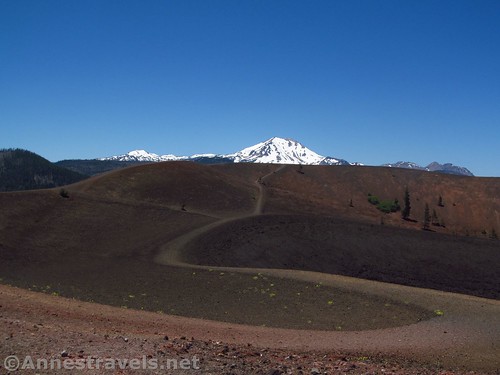 Trails lead around the rims of the Cinder Cone with Lassen Peak beyond in Lassen Volcanic National Park, California