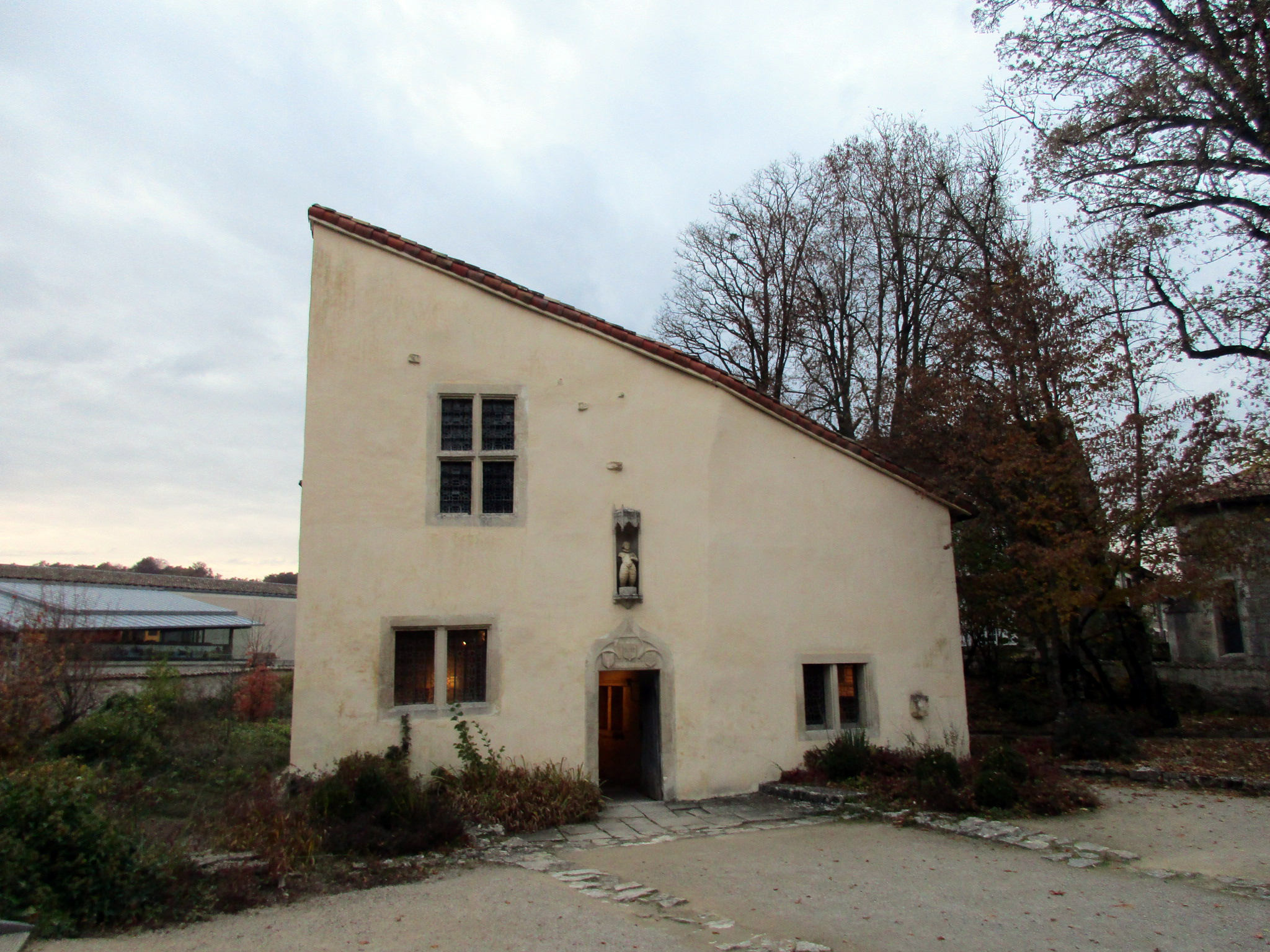 Joan's birthplace in Domrémy is now a museum. The village church where she attended Mass is to the right, behind the trees. Photo taken by <a href=