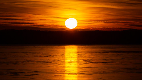 pewaukeelake sunset reflection ice frozen lake wisconsin canoneos5dmarkiii canonef100400mmf4556lisusm sun clouds sky horizon contrast johnwestrock