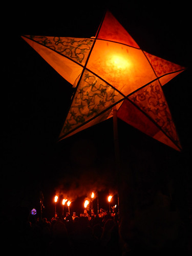 A star-shaped lantern floats above the torches at the Winter Solstice Festival on Granville Island in Vancouver