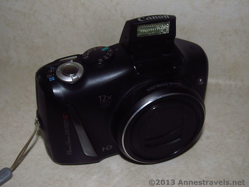 Front view of the Canon PowerShot SX150 IS - the flash is up in this picture