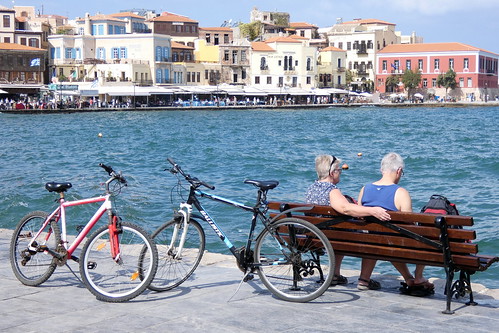 chania holiday crete greece 2018 two cyclists harbour sea