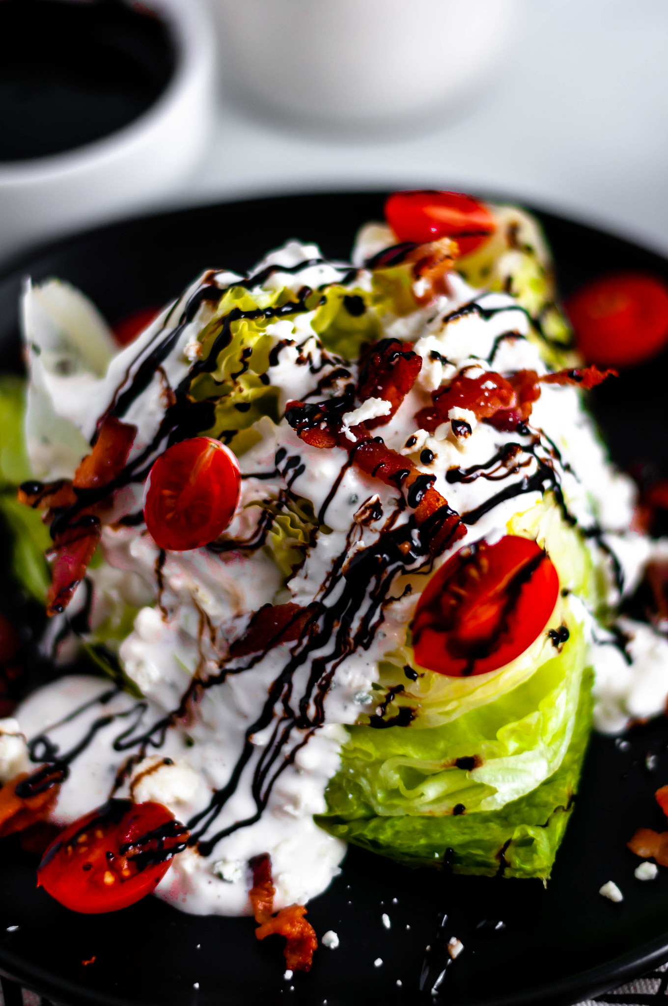 Start off any meal with this Classic Wedge Salad. Homemade blue cheese and a drizzle of balsamic glaze provide so much flavor to this classic salad.