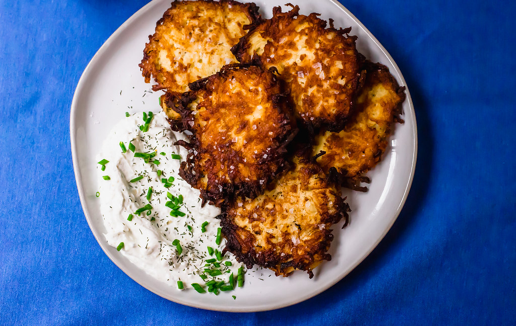 A play on the traditional potato latkes, these salt and vinegar potato latkes have a hint of sourness from the vinegar and a healthy sprinkle of sea salt. Serve along side onion and chive sour cream for a fun play on latkes.