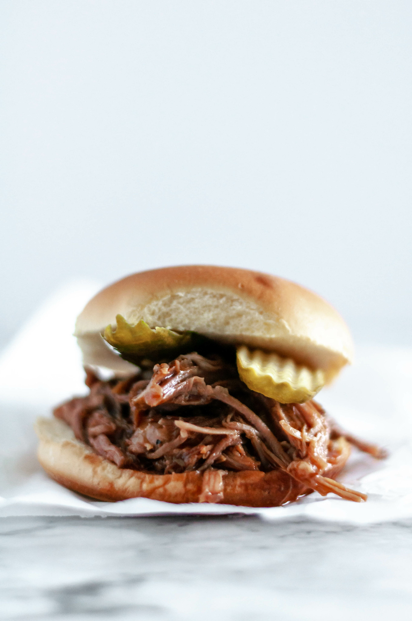 Rootbeer BBQ Pulled Pork Sandwiches are super simple to make in the slow cooker. Four ingredients & hours in the slow cooker to tender, saucy perfection.