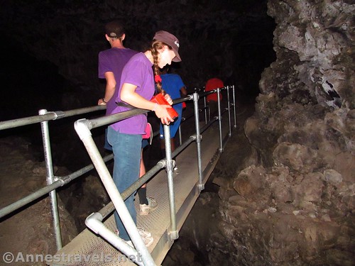 Enjoying a catwalk over a lower chasm in Sentinel Cave, Lava Beds National Monument, California