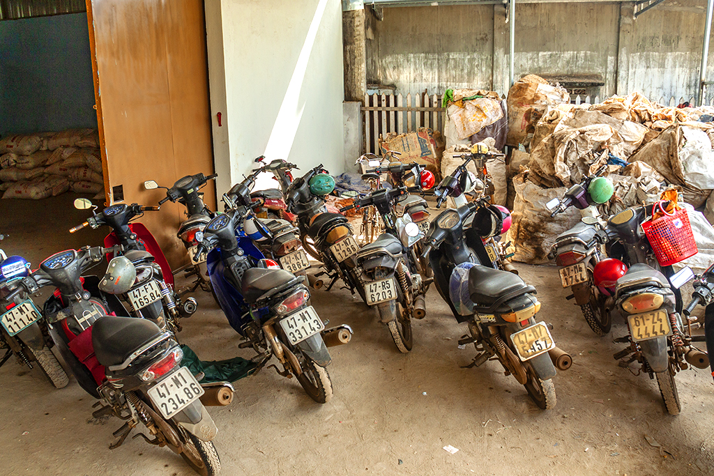 Workers' motrobikes at plastic recycling plant--Ea Kly