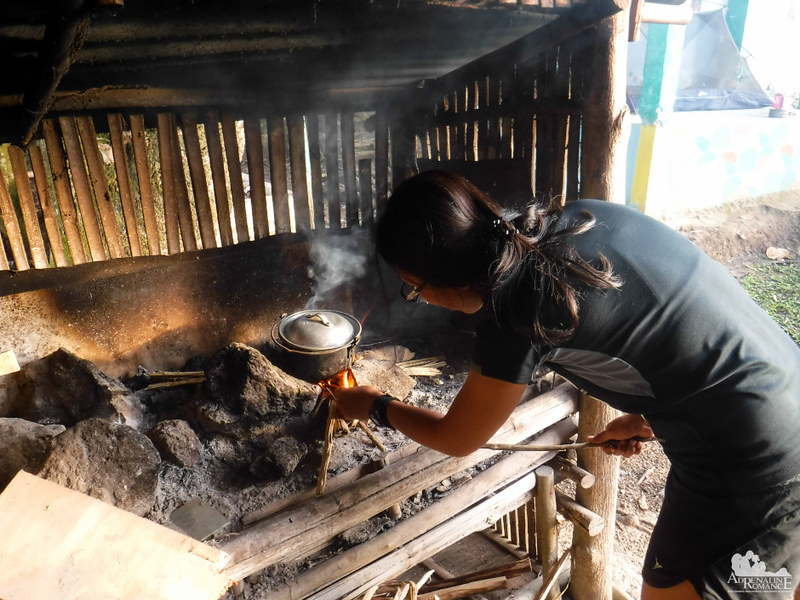 Cooking rice in a wooden stove