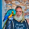 Man with a colourful Macaw (parrot) on his shoulder. This image is provided on an as-is basis, royalty free for personal editorials, blogs and web display usage. - Royalty Free People & Candid Situations