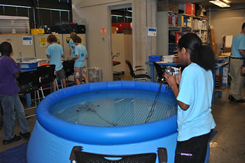 Student from Waterbotics Camp maneuvering it underwater