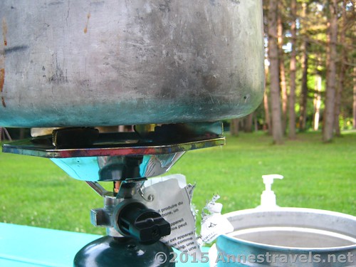 A close up of the top of the Coleman Propane Single Burner Stove - the black screw clamps the top to the neck of the propane bottle.