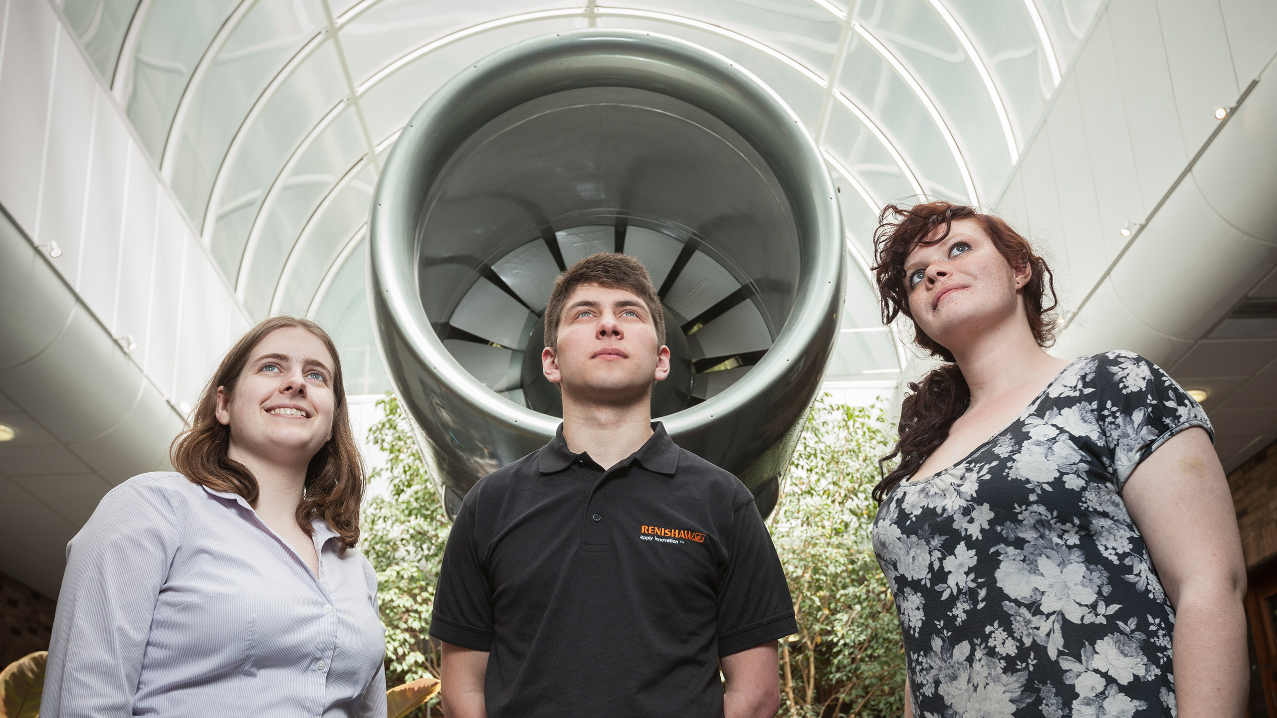 Students on placement at Renishaw look upwards under a turbine