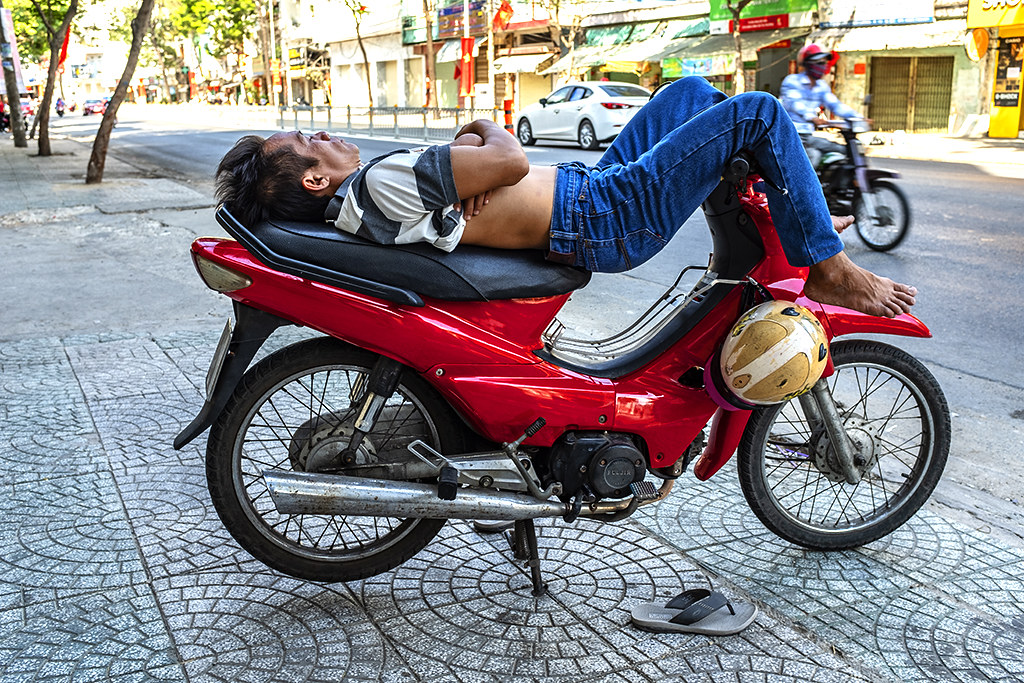Man sleeping on motorbike on Nguyen Van Luong--Saigon