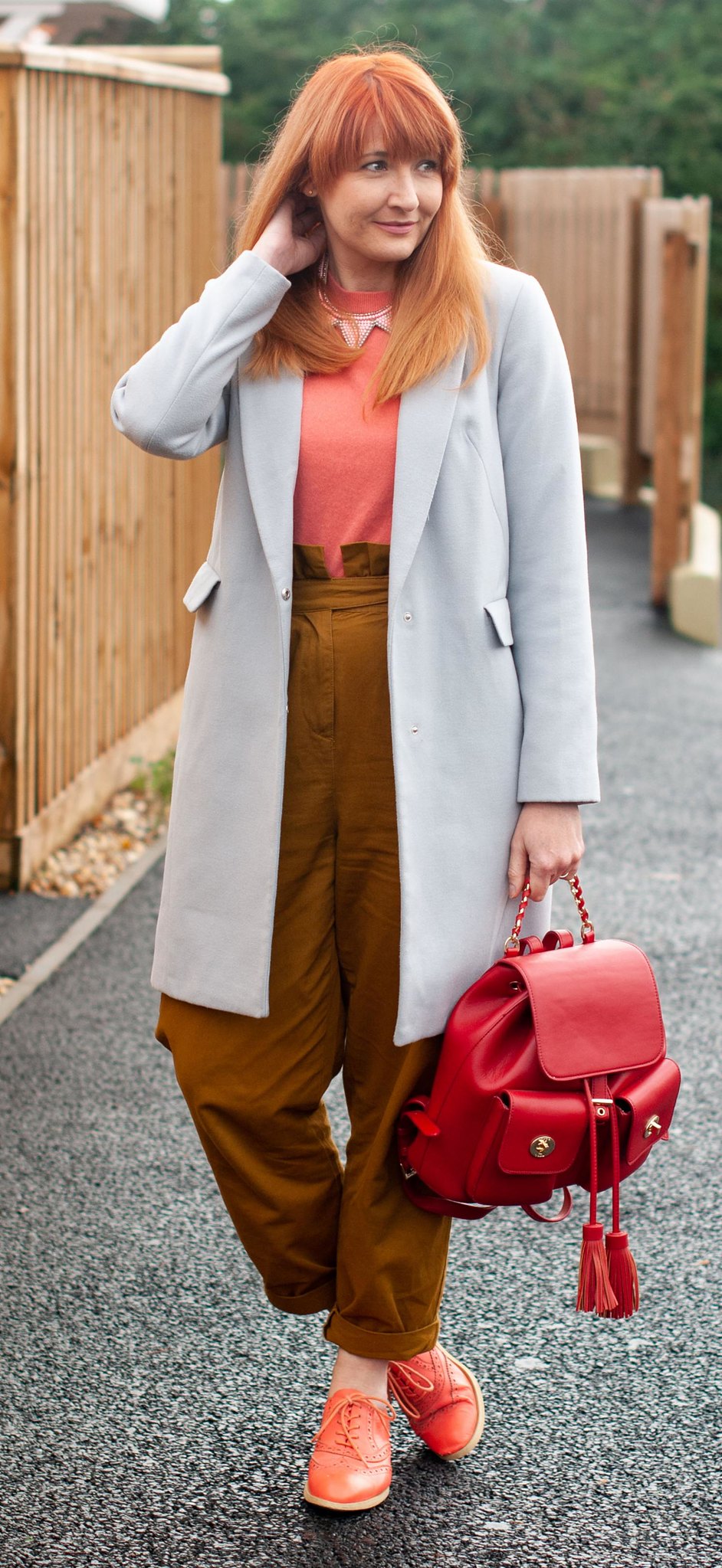 Wearing The Pantone Color of the Year 2019, Living Coral (My Favourite So Far) \ grey duster coat \ tobacco brown peg leg trousers \ coral brogues \ orange Oxfords \ coral cashmere sweater \ red backpack | Not Dressed As Lamb, over 40 style blog