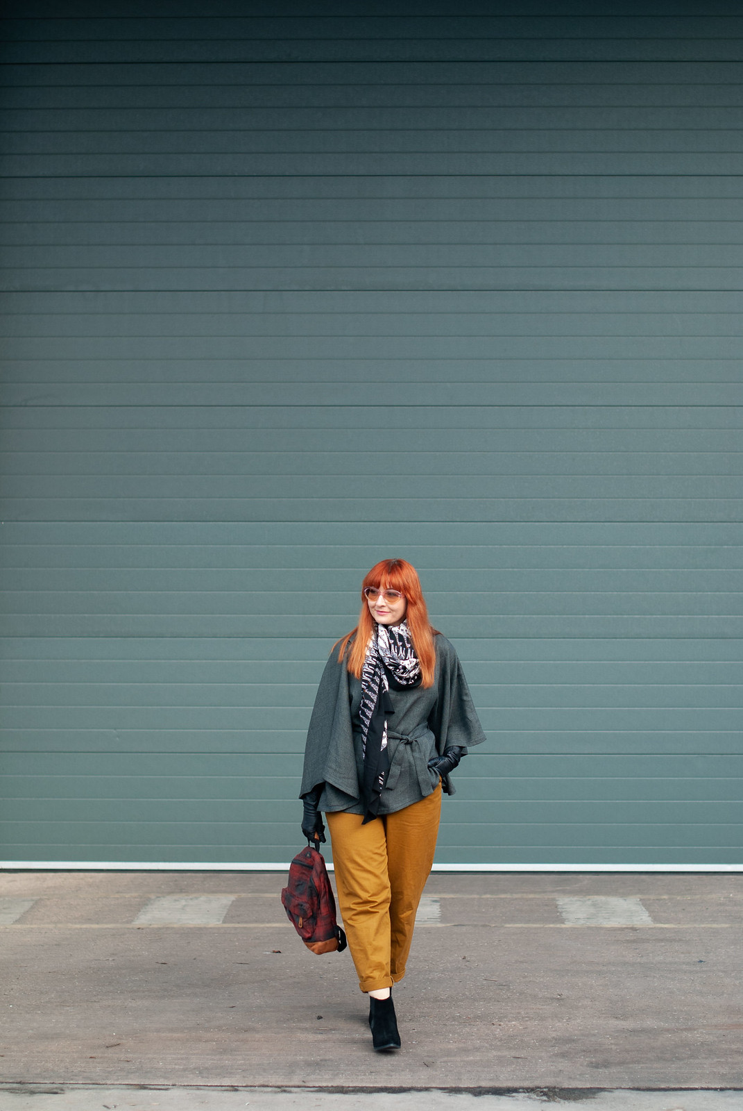 How to Make a Plain Grey Poncho Much More Exciting \ with mustard peg leg trousers \ giraffe print scarf \ black ankle boots \ tartan plaid backpack \ pastel sunglasses | Not Dressed As Lamb, over 40 style