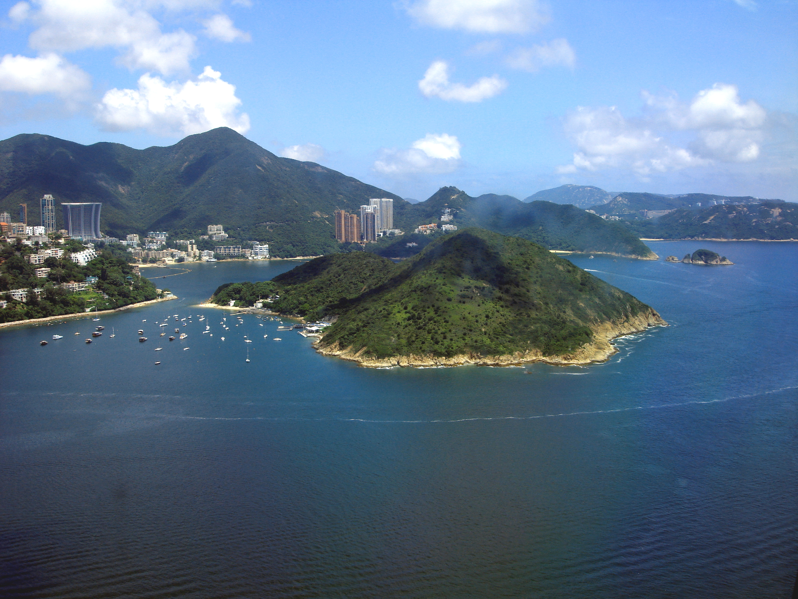 View of Middle Island, off Hong Kong Island (left) between Deep Water Bay and Repulse Bay (background, left). Viewed from the Ocean Park cable car ride. Repulse Bay is in the southern part of Hong Kong Island, located in the Southern District. It is one of the most expensive residential areas in Hong Kong. Photo taken on August 16, 2006.