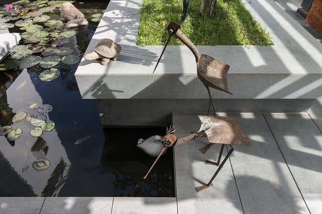 Various animal sculptures around the water bodies in landscape of this tropical bungalow