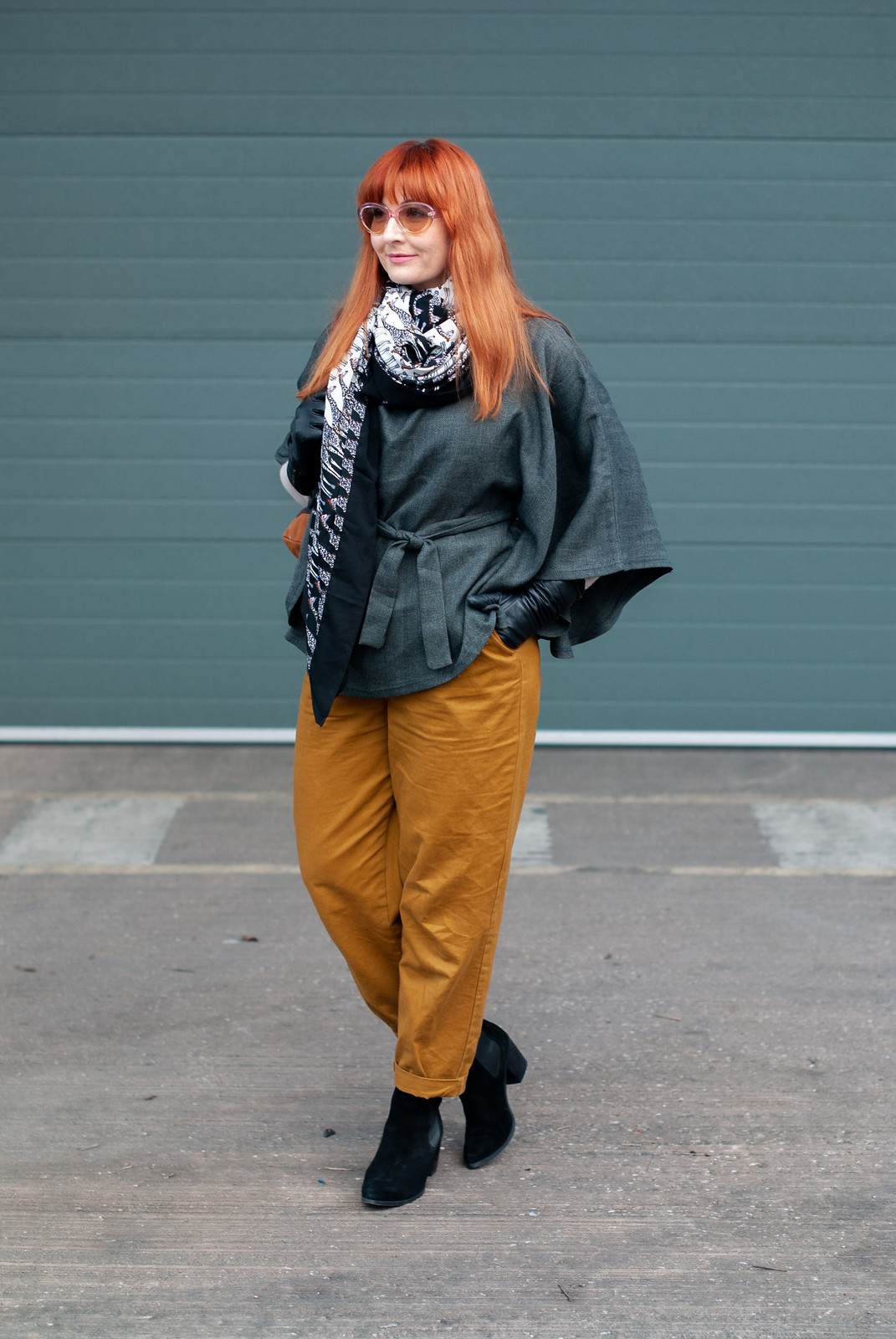 How to Make a Plain Grey Poncho Much More Exciting \ with mustard peg leg trousers \ giraffe print scarf \ black ankle boots \ tartan plaid backpack \ pastel sunglasses | Not Dressed As Lamb, over 40 style
